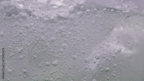 Carbonated water poured into a glass with ice.