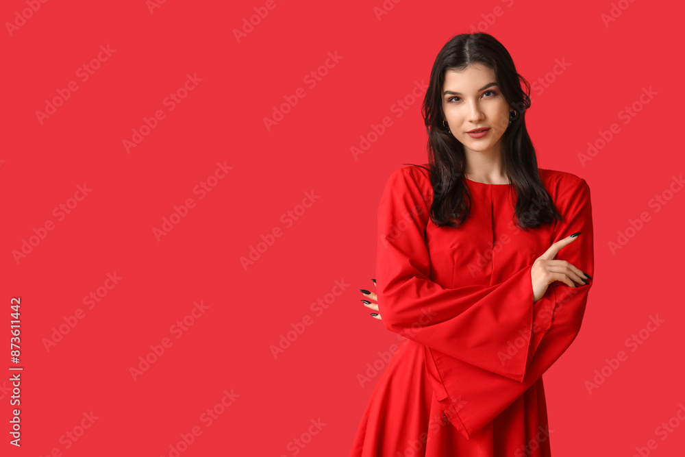 Fototapeta premium Beautiful young woman in stylish red dress on color background