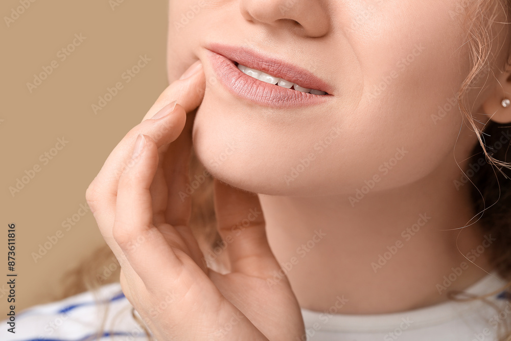 Beautiful young woman suffering from toothache on brown background, closeup Beautiful young woman suffering from toothache on brown background, closeup