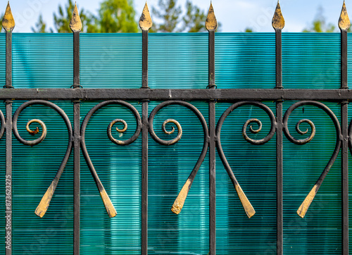 A metal fence with sharp peaks in close-up. photo