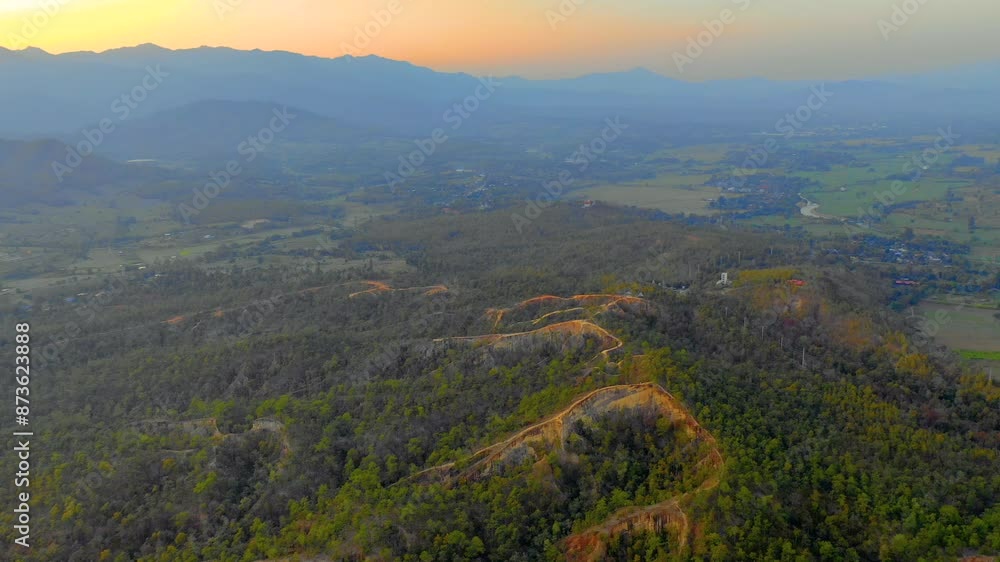 Stunning sunset aerial over the mountains in the Thai countryside. Stunning sunset aerial over the mountains in the Thai countryside.