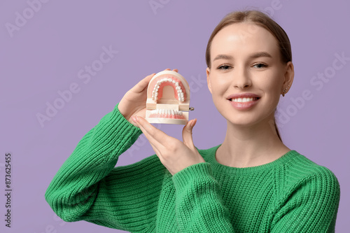 Young woman with jaw model ...