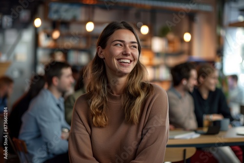 Close-up photo portrays the animated reactions of a group of businesswoman and participants as they laugh and listen attentively to startup business owner at trade show exhibition event.