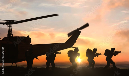 Military helicopter special force commando unit drop-off at sunset