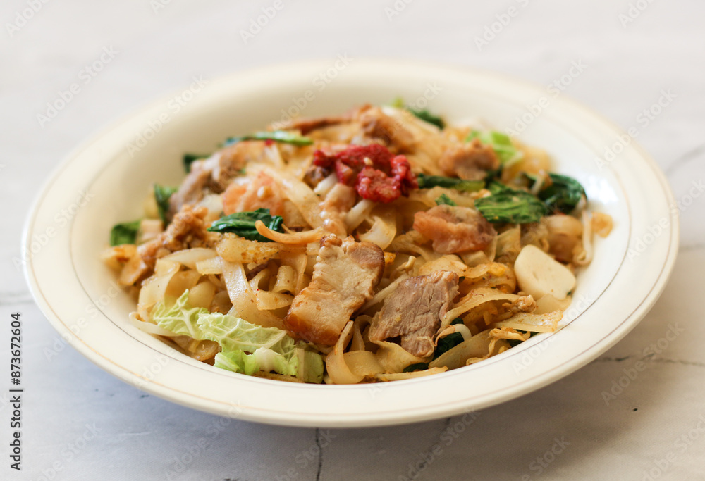 Kwetiau siram with vegetable and pork. Kwetiau siram with vegetable and pork.