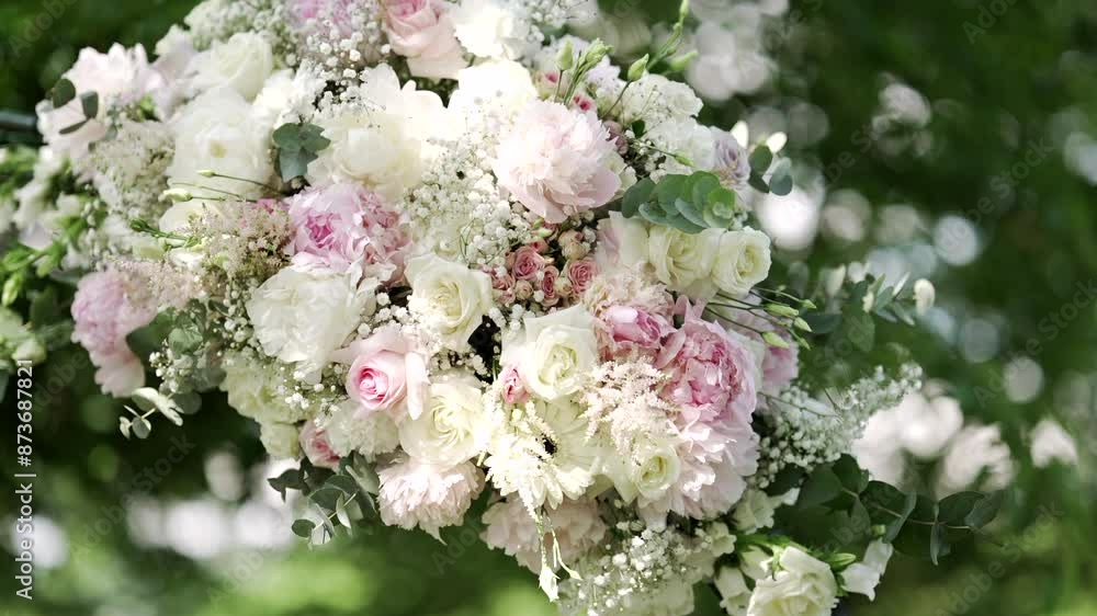 Beautiful floral arrangement with white and pink roses in a lush outdoor setting. Beautiful floral arrangement with white and pink roses in a lush outdoor setting.