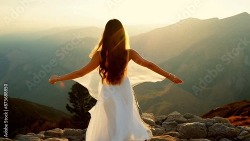 medium shot, woman in white dress, standing on top of mountain, raised hands, wind blowing dress and long hair, freedom, nature, slow movement