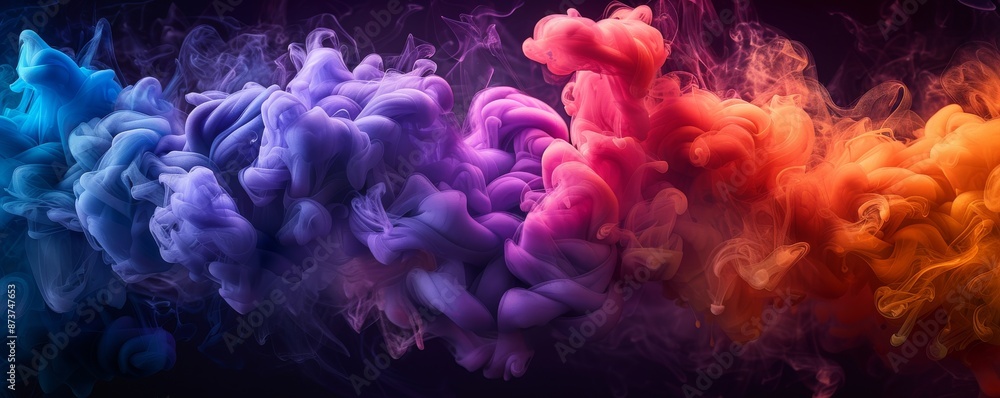 Obraz premium Colorful smoke explosion of vibrant colors in dark background