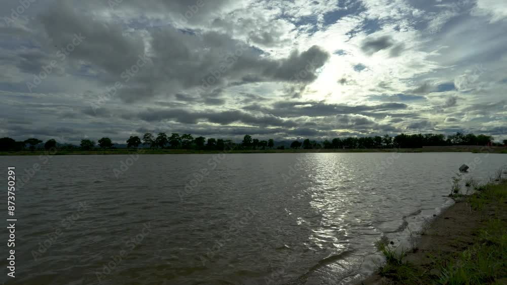 Wide angle view of sunset at the lake during cloudy, rainy weather. Wide angle view of sunset at the lake during cloudy, rainy weather.