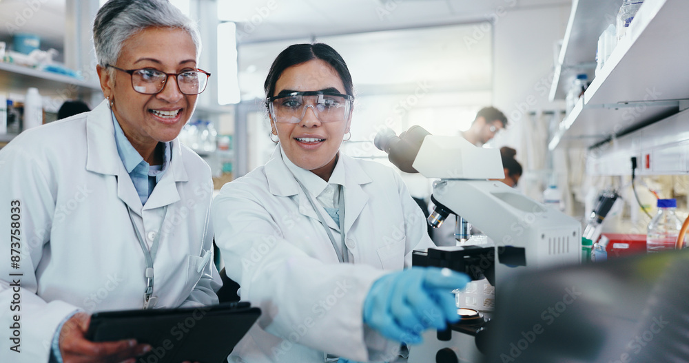 Laboratory, women scientist and teamwork with microscope for medical research and diagnosis with tech. Females biologist, tablet and laptop for treatment, information and collaboration for analysis Laboratory, women scientist and teamwork with microscope for medical research and diagnosis with tech. Females biologist, tablet and laptop for treatment, information and collaboration for analysis