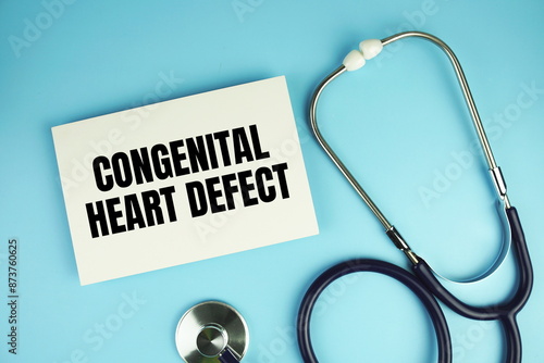 Congenital Heart Defect text on paper card with stethoscope top view on blue background photo