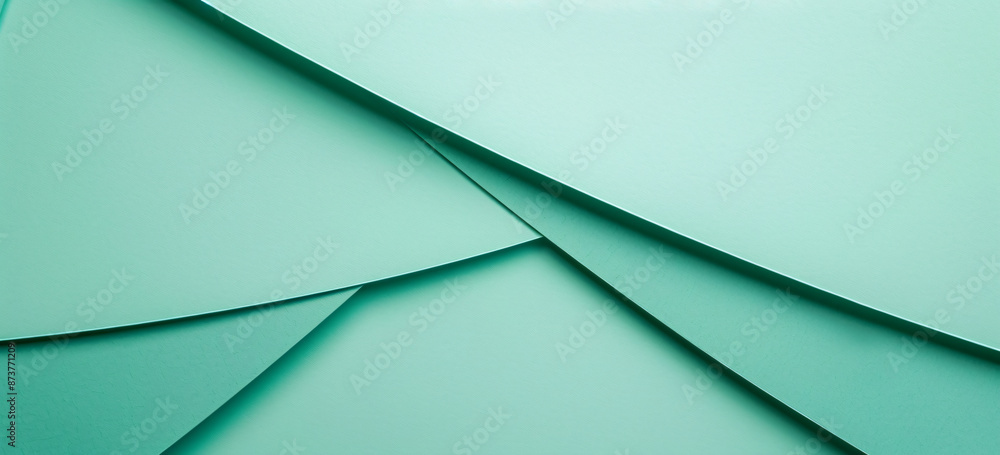 Fototapeta premium Photo of a minimalist mint green background with geometric shapes for design or text space. Web banner with copy space on the right in the style of minimalism.