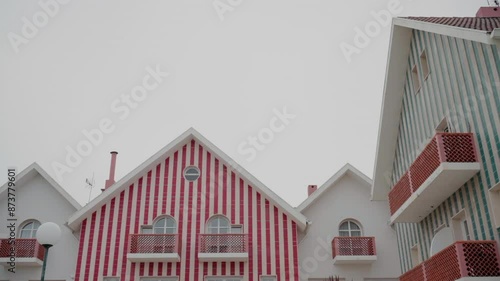 Striped houses with red and blue accents in the center of Aveiro, Portugal.