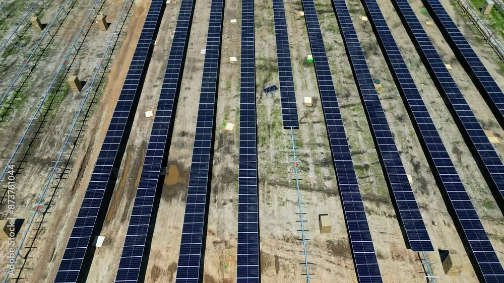 Row of solar panels on construction site for new power plant, aerial establisher Row of solar panels on construction site for new power plant, aerial establisher
