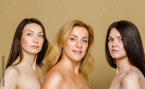 Multi-Generational Women Portrait Showcasing Diverse Beauty. Portrait of three women from different generations, each presenting unique beauty and age characteristics on a beige background.