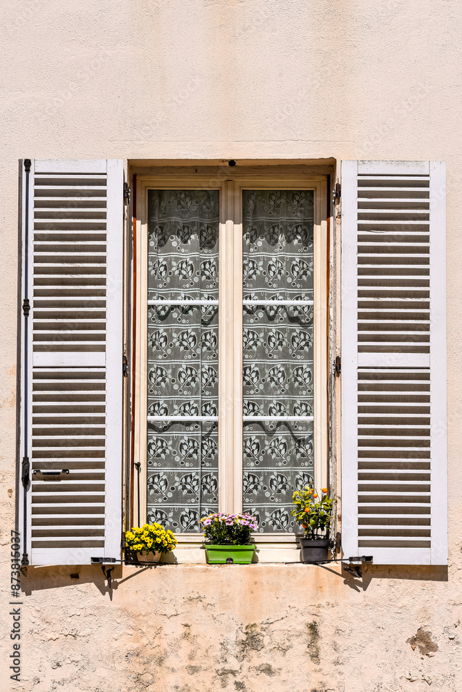 old window with shutters and flowers