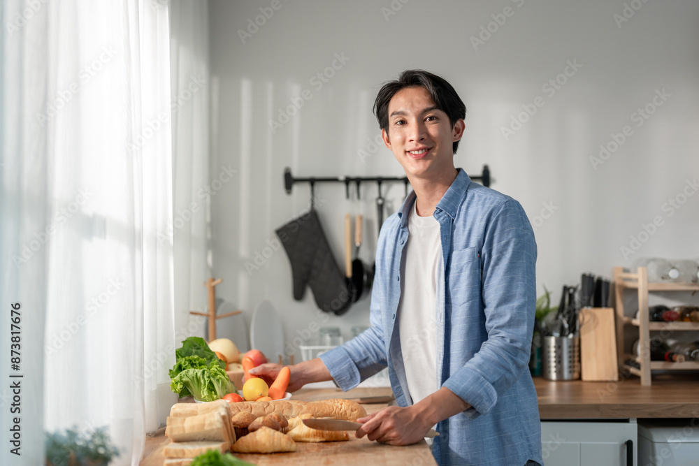 Portrait of Asian young man baking bakery alone in kitchen at home. Portrait of Asian young man baking bakery alone in kitchen at home.