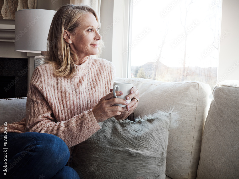 Mature woman, coffee and couch by window with smile for thinking, memory and insight in home. Person, tea cup and relax on sofa in lounge, remember and reflection with nostalgia at house in Croatia Mature woman, coffee and couch by window with smile for thinking, memory and insight in home. Person, tea cup and relax on sofa in lounge, remember and reflection with nostalgia at house in Croatia