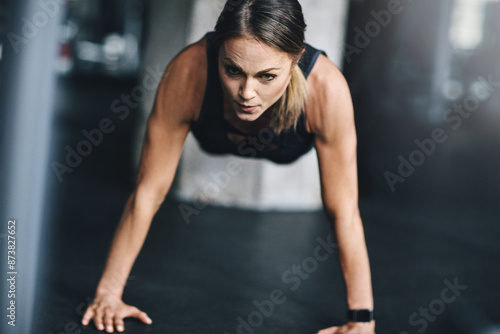 Push ups, woman and fitness in gym on floor for workout, health and wellness with power or resilience. Plank, athlete and training in sports club for exercise, competition and body goals with muscle