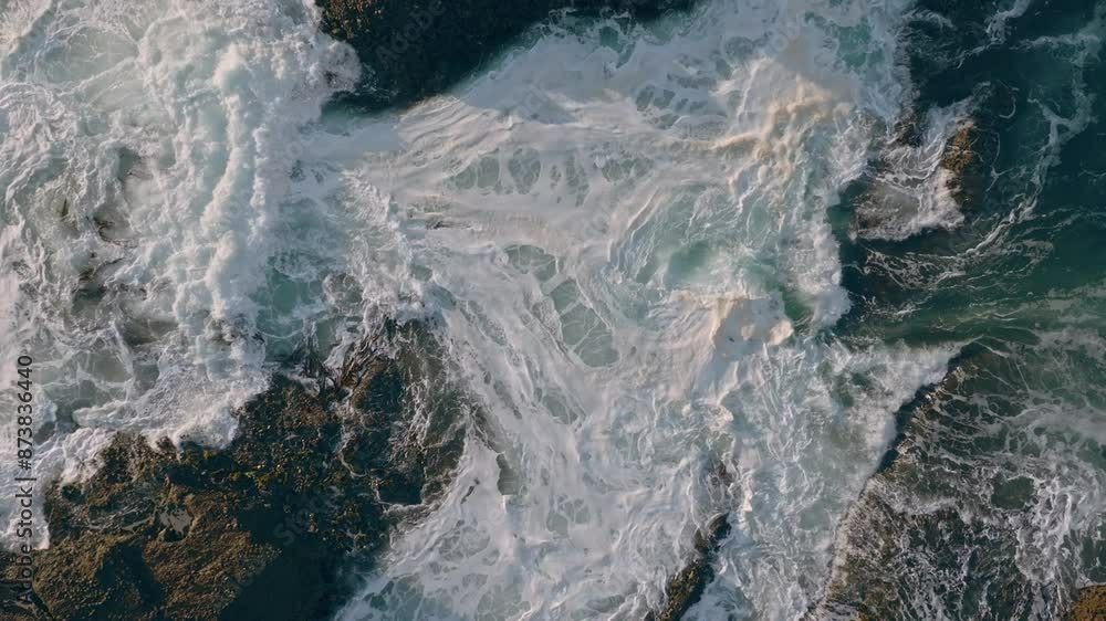 Abstract whitewash of waves crashing over rocks. Piha, Auckland, New Zealand.