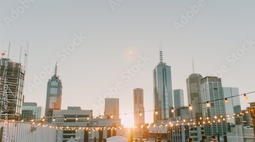 An urban rooftop garden party with fairy lights strung between buildings people mingling with glasses of rosé a live jazz band playing smooth tunes and a stunning sunset casting a warm glow over the c