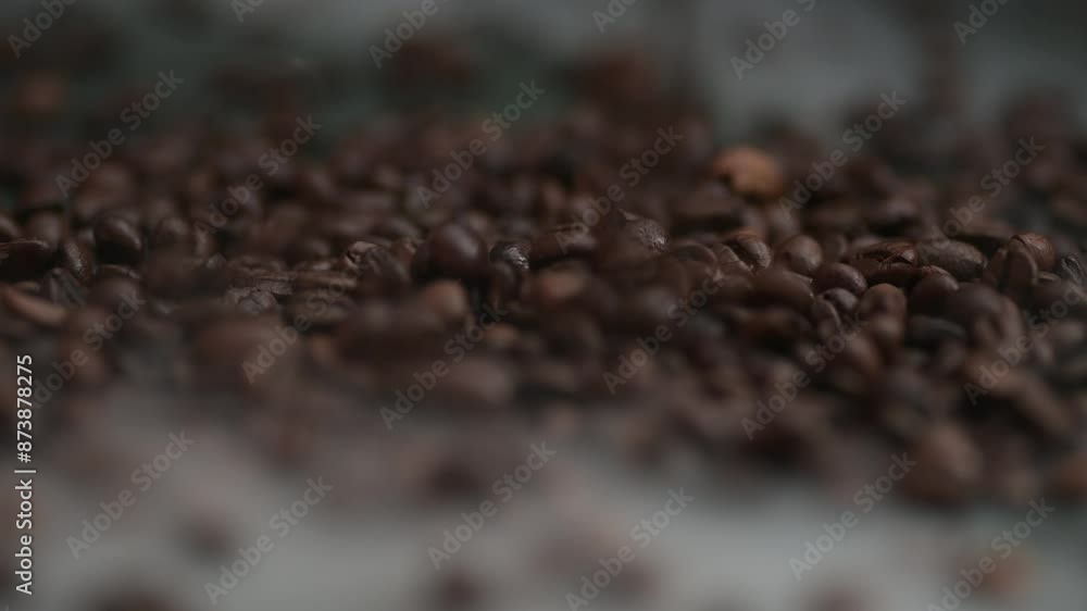 Close-up coffee beans falling, spilling onto the table into smoke, fog Close-up coffee beans falling, spilling onto the table into smoke, fog