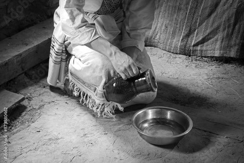 Male slave serve in the house pouring water