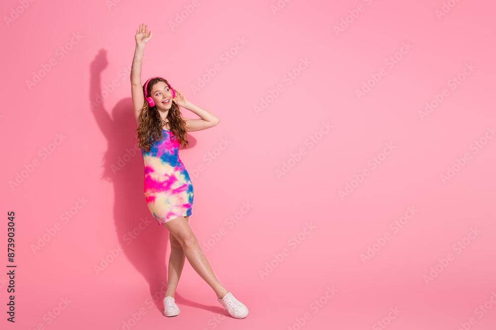 Full length photo of cheerful pretty lady dressed vintage clothes headphones dancing empty space isolated pink color background Full length photo of cheerful pretty lady dressed vintage clothes headphones dancing empty space isolated pink color background