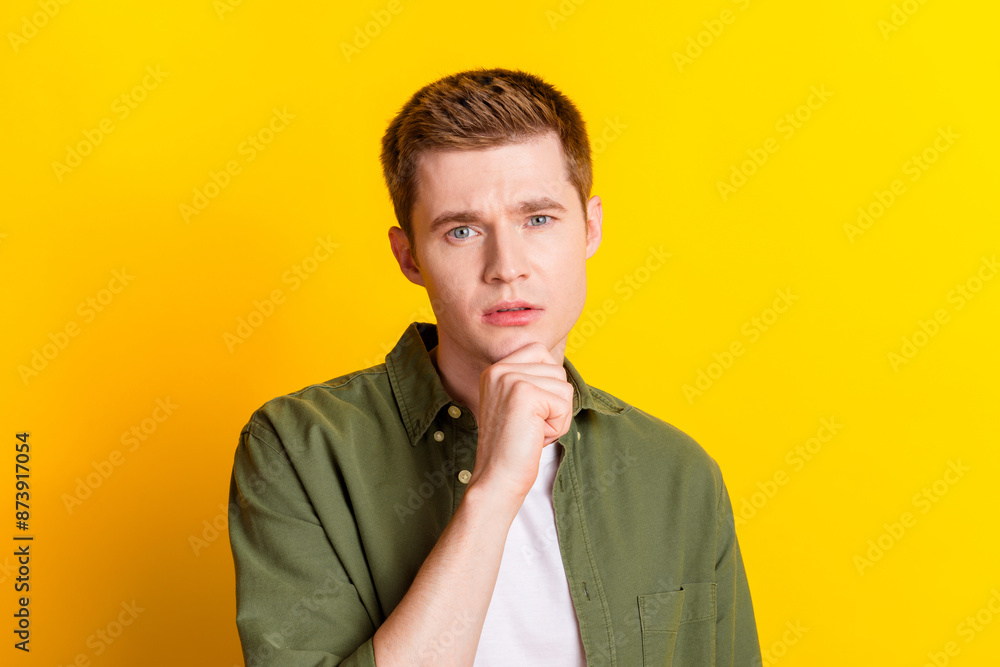 Photo of handsome smart man wear stylish khaki clothes arm touch face isolated on vivid yellow color background Photo of handsome smart man wear stylish khaki clothes arm touch face isolated on vivid yellow color background