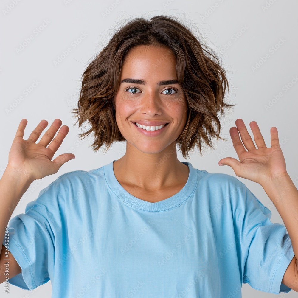 6. American Latina woman with a pixie cut, dressed in a plain light blue oversized crew neck t-shirt, standing with arms open wide and smiling broadly, isolated on white background 6. American Latina woman with a pixie cut, dressed in a plain light blue oversized crew neck t-shirt, standing with arms open wide and smiling broadly, isolated on white background