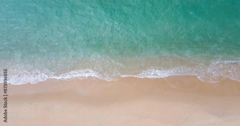 Aerial view drone shot Top-view of beach and sea, Seawater wave on sandy beach. Beach on the tropical island. (4K DCI 4096x2160p 10bit 4:2:2)