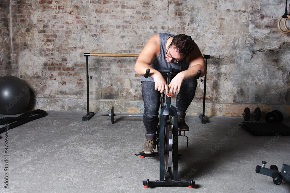 Lazy fat man doing fitness in the gym. Lazy fat man doing fitness in the gym.