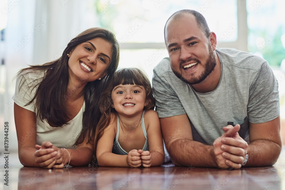 Parents, girl and happy in home on floor on portrait for fun, bonding and support for child development. People, couple and smile with kid or daughter in living room for love, relax and memories Parents, girl and happy in home on floor on portrait for fun, bonding and support for child development. People, couple and smile with kid or daughter in living room for love, relax and memories
