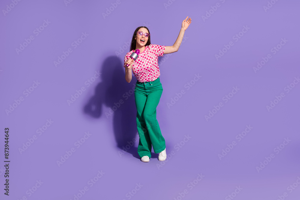 Full length photo of lovely young lady sing karaoke singer dressed stylish pink garment isolated on violet color background Full length photo of lovely young lady sing karaoke singer dressed stylish pink garment isolated on violet color background