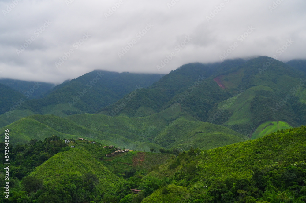 Fototapeta premium village on hill at mountain