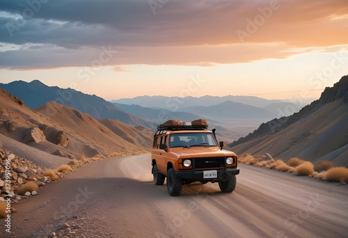 An orange off-road car traveling through desert mountain valleys