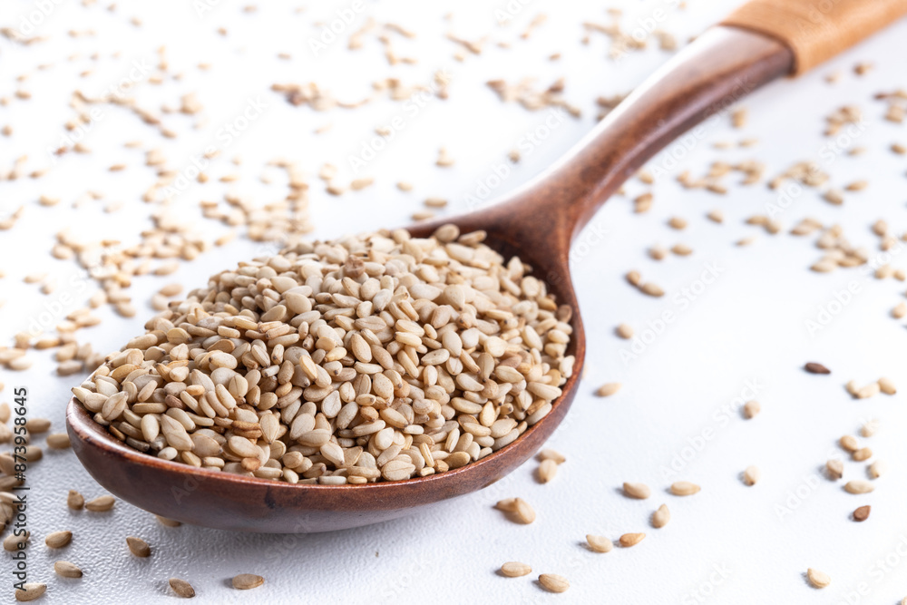 Rolled oats on wooden spoon isolated on white background, healthy breakfast cereal oat flakes Rolled oats on wooden spoon isolated on white background, healthy breakfast cereal oat flakes