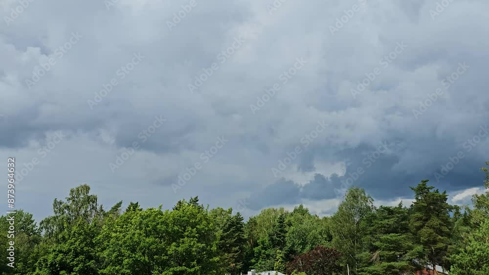 Beautiful timelapse of stormy clouds moving in the sky above the trees in Helsinki city Beautiful timelapse of stormy clouds moving in the sky above the trees in Helsinki city