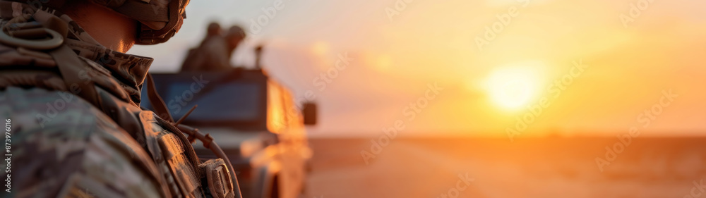 Obraz premium Military patrol car on sunset background, army war concept
