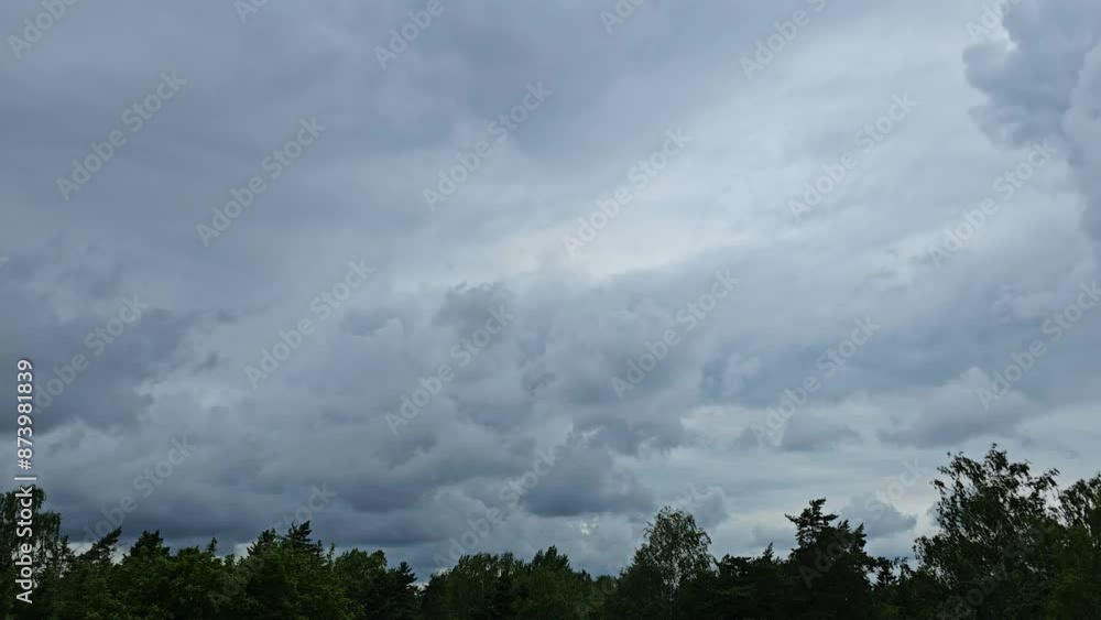 Beautiful timelapse of stormy clouds moving in the sky above the trees in Helsinki city Beautiful timelapse of stormy clouds moving in the sky above the trees in Helsinki city