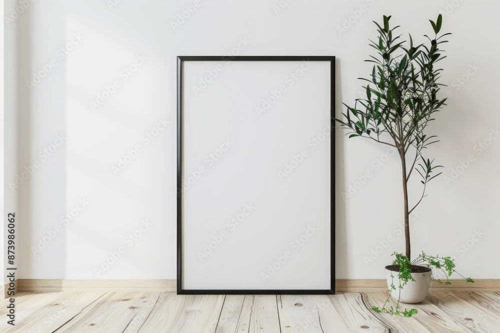 Black Poster. Blank Vertical Frame Mockup on Light Wooden Floor Next to White Wall Black Poster. Blank Vertical Frame Mockup on Light Wooden Floor Next to White Wall