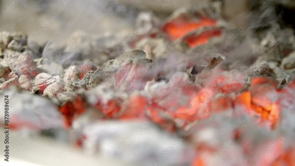 Close-up of glowing embers, showcasing the intense heat and vibrant colors of hot coals in a barbecue setting. Highlights the fiery details and smoky atmosphere, emphasizing the raw power of live fire Close-up of glowing embers, showcasing the intense heat and vibrant colors of hot coals in a barbecue setting. Highlights the fiery details and smoky atmosphere, emphasizing the raw power of live fire
