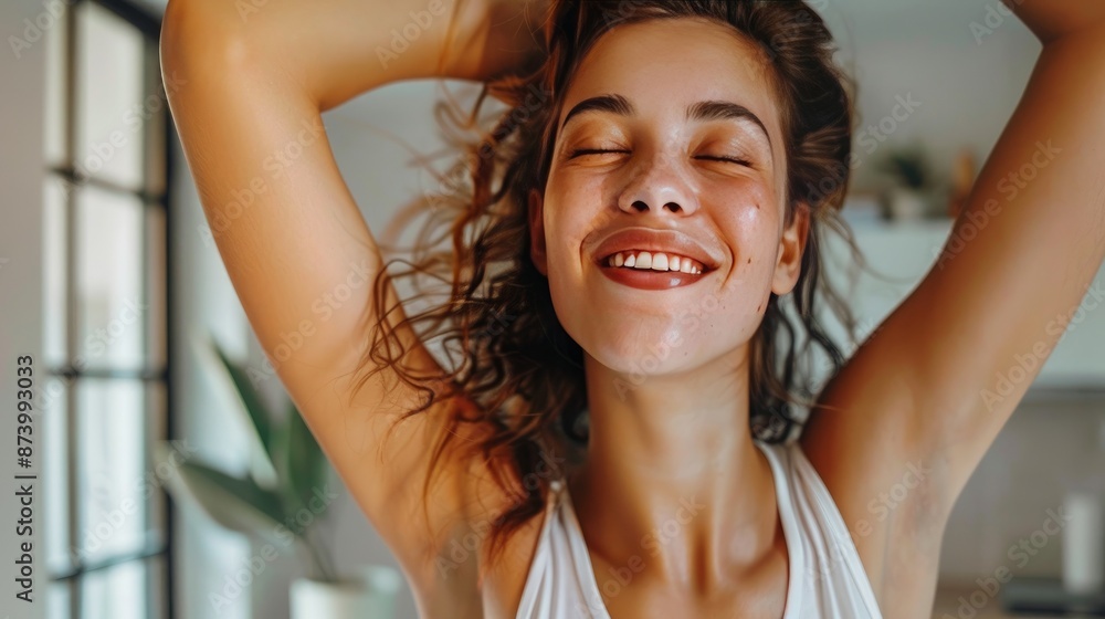 Close-up of happy woman uses deodorant spray on her underarm at home Close-up of happy woman uses deodorant spray on her underarm at home