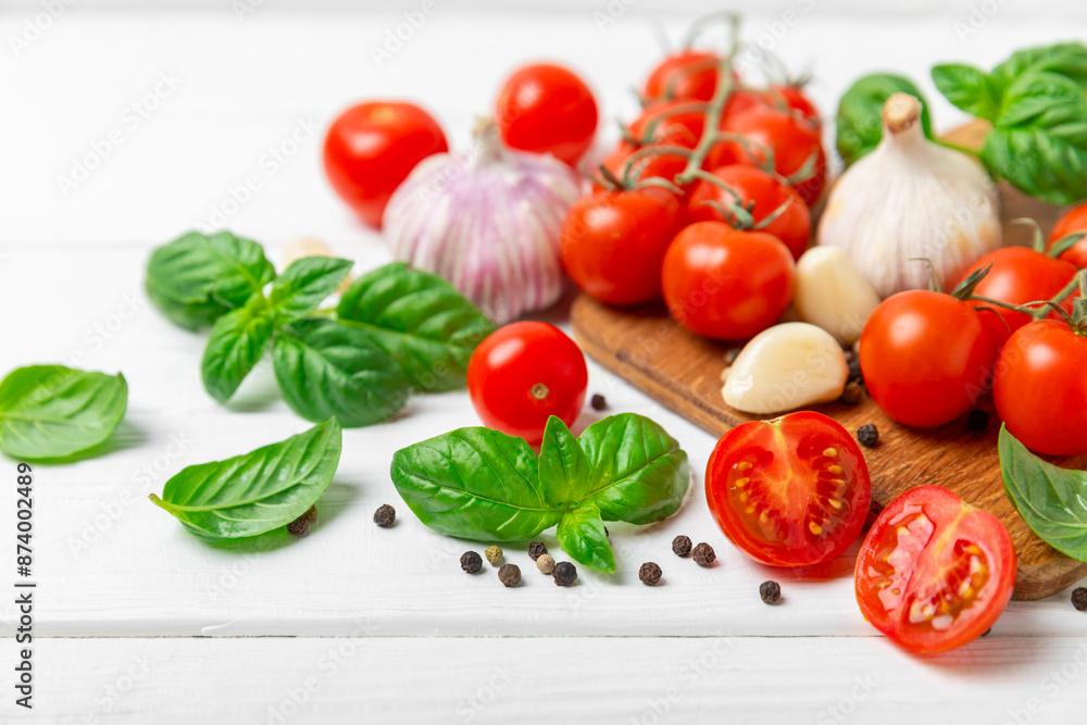 Fresh cherry tomatoes and fresh green basil on a textured background. Tomato sauce. Vegan. Ingredients for salad. Organic food. Place for text. Copy space. Fresh cherry tomatoes and fresh green basil on a textured background. Tomato sauce. Vegan. Ingredients for salad. Organic food. Place for text. Copy space.