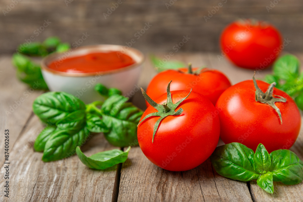 Fresh cherry tomatoes and fresh green basil on a textured background. Tomato sauce. Vegan. Ingredients for salad. Organic food. Place for text. Copy space. Fresh cherry tomatoes and fresh green basil on a textured background. Tomato sauce. Vegan. Ingredients for salad. Organic food. Place for text. Copy space.