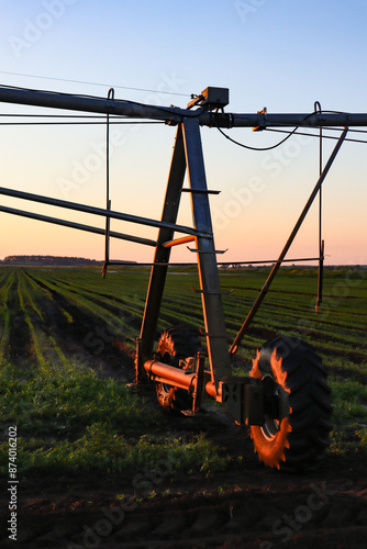 Field with mobile Irrigation system for water supply. Automatic field watering system.