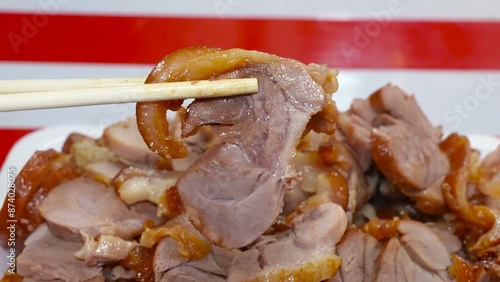 Succulent pork legs, simmered in a special broth, are presented cut into portions.