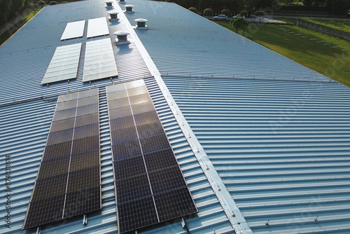 Aerial view of solar panels on industrial roof photo