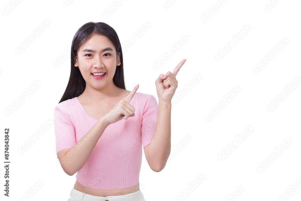 Young asian woman in black long hair wears pink shirt and shows point up to present something confidently while isolated white background. Young asian woman in black long hair wears pink shirt and shows point up to present something confidently while isolated white background.