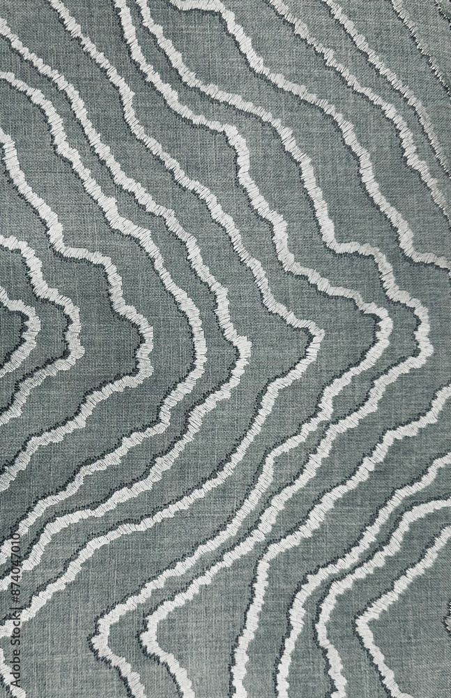 closeup of abstract wavy pattern with white thread on the grey textile or fabric. Pattern design on the fabric. closeup of abstract wavy pattern with white thread on the grey textile or fabric. Pattern design on the fabric.